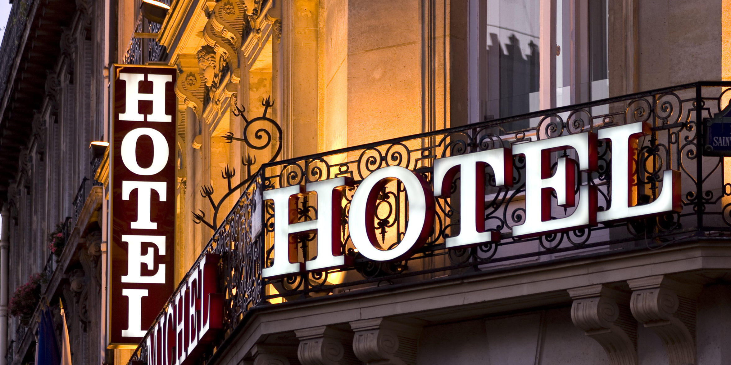 Illuminated Parisian hotel sign taken at dusk